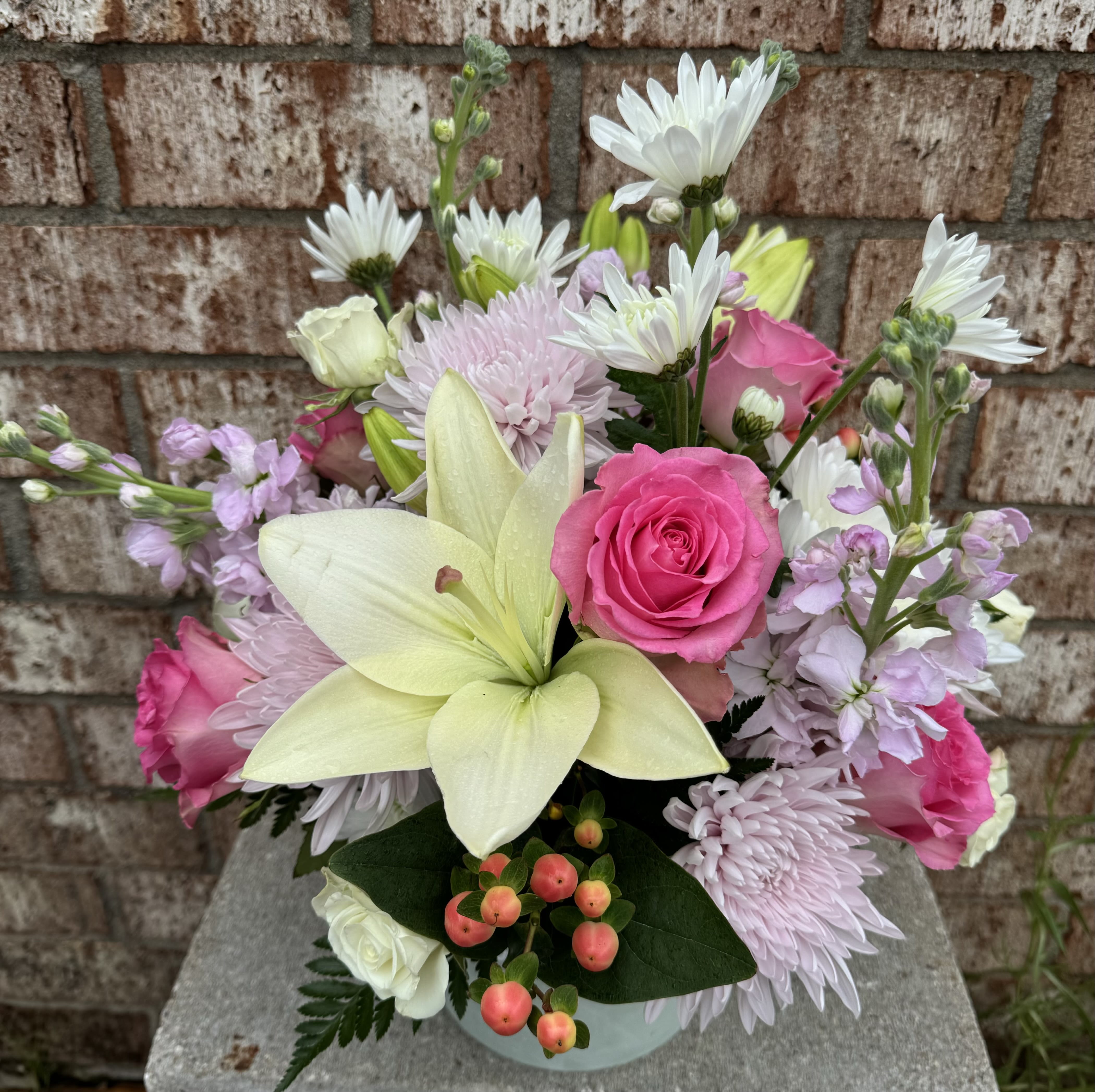 Memorial Garden Flowers - A garden of heavenly blooms offers an elegant and timeless tribute, beautifully honoring the spirit of the most precious departed.  **We have different containers in stock that are similar in size and shape, but we currently do not have the container shown.** If you would like to have input in the container choice, please call the shop. 