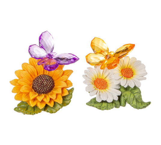 Two small floral figurines with sunflowers and daisies topped by butterfly accents