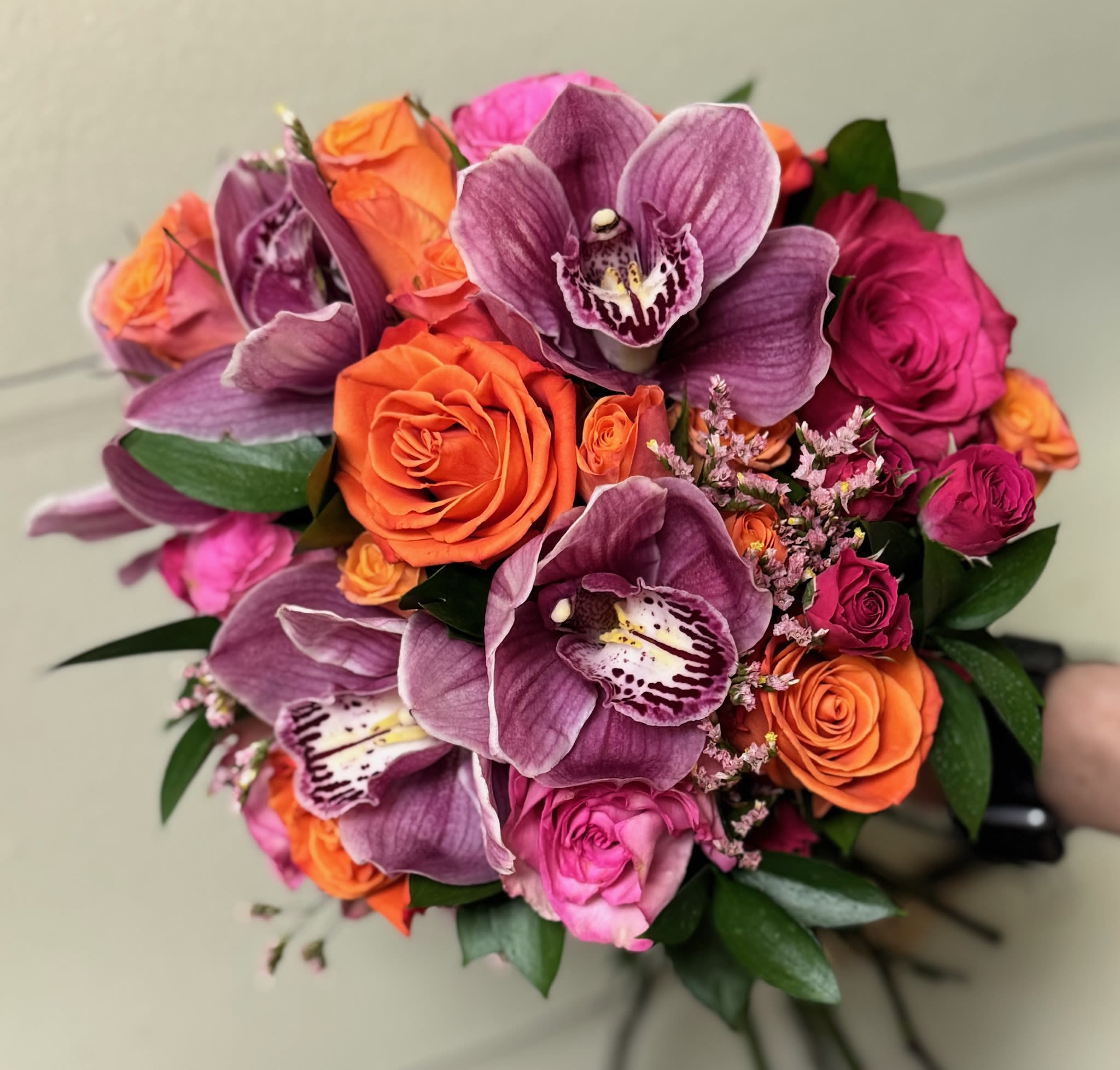 Bouquet of purple orchids and orange and pink roses