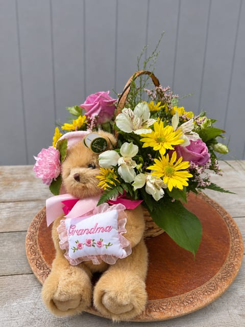 Grandma's Basket  - Grandma’s Basket  A warm and nostalgic arrangement inspired by the kind of love that only a grandmother can give.  Designed in a classic basket, Grandma’s Basket features a generous mix of blooms including roses, daisies, button poms, cremons, carnations, mini carnations, and statice. The blend of textures and colors creates a full, garden-style arrangement that feels comforting, joyful, and timeless.  Each design is thoughtfully arranged using a mix of seasonal colors, making every basket unique and full of character.  Perfect for Mother’s Day, this arrangement is a beautiful way to honor grandmothers and the special women who have loved, nurtured, and cared for us through the years.
