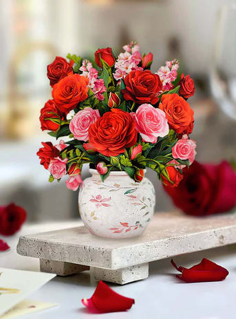 Bouquet of red and pink roses in a white floral vase
