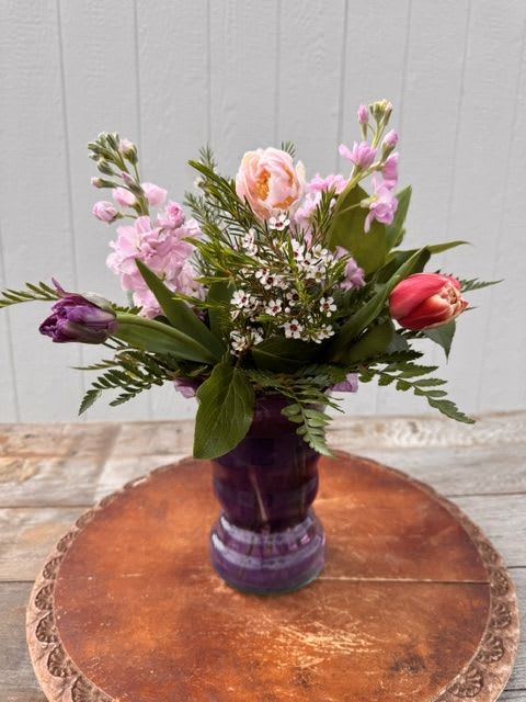 Cheerful Tulips Bouquet - Cheerful Tulips  A bright and joyful arrangement designed to celebrate the beauty of the season and the women who make life so special.  Cheerful Tulips features a vibrant mix of tulips in assorted colors, complemented by soft stock and delicate wax flower for added texture and fullness. The result is a fresh, garden-inspired design that feels both lively and elegant.  Standard includes six tulips, three stems of stock, and wax flower. Deluxe includes twelve tulips, four stems of stock, and wax flower.  Thoughtfully designed for Mother’s Day, this arrangement is a cheerful way to share love, color, and happiness with someone who means so much.