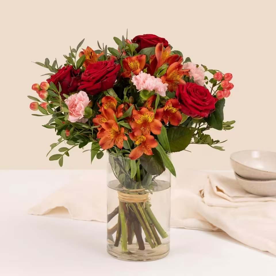 Embrace  - Mixed bouquet in warm tones with red roses and orange alstroemeria