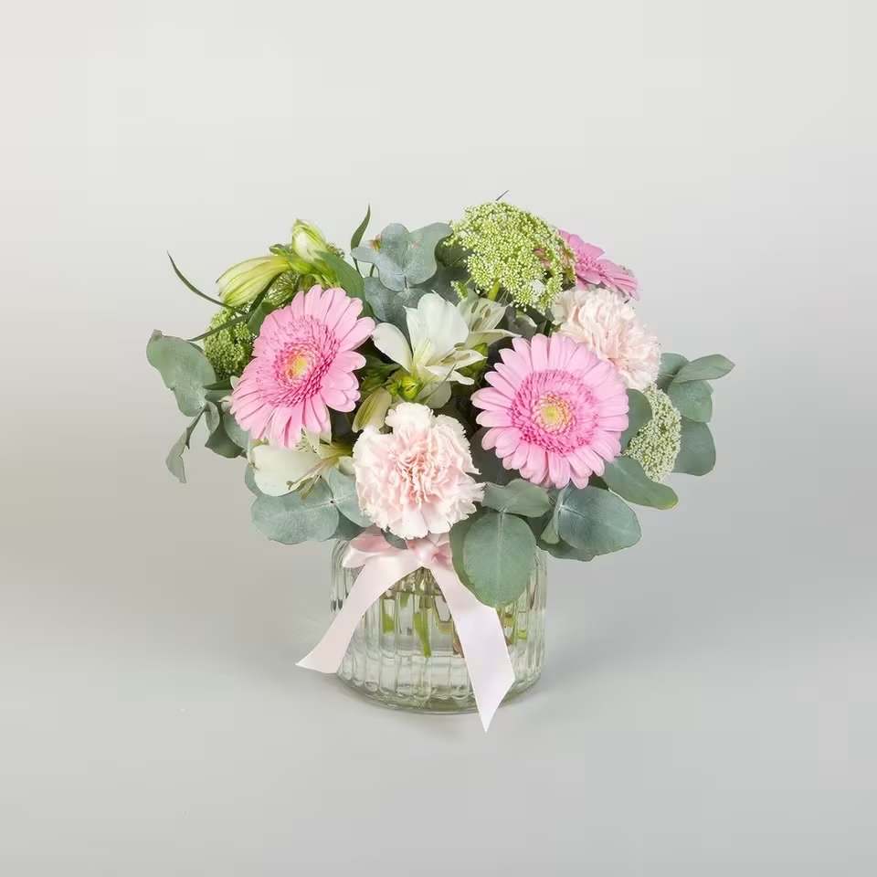 Petite Classic Pink - This cute yet classic pink floral arrangement is a gorgeous way to send your congratulations or birthday wishes. Stunning pinks tones for gerberas and carnations are highlighted by green for a full textured arrangement. Presented in a glass vase, they will love this flower gift.