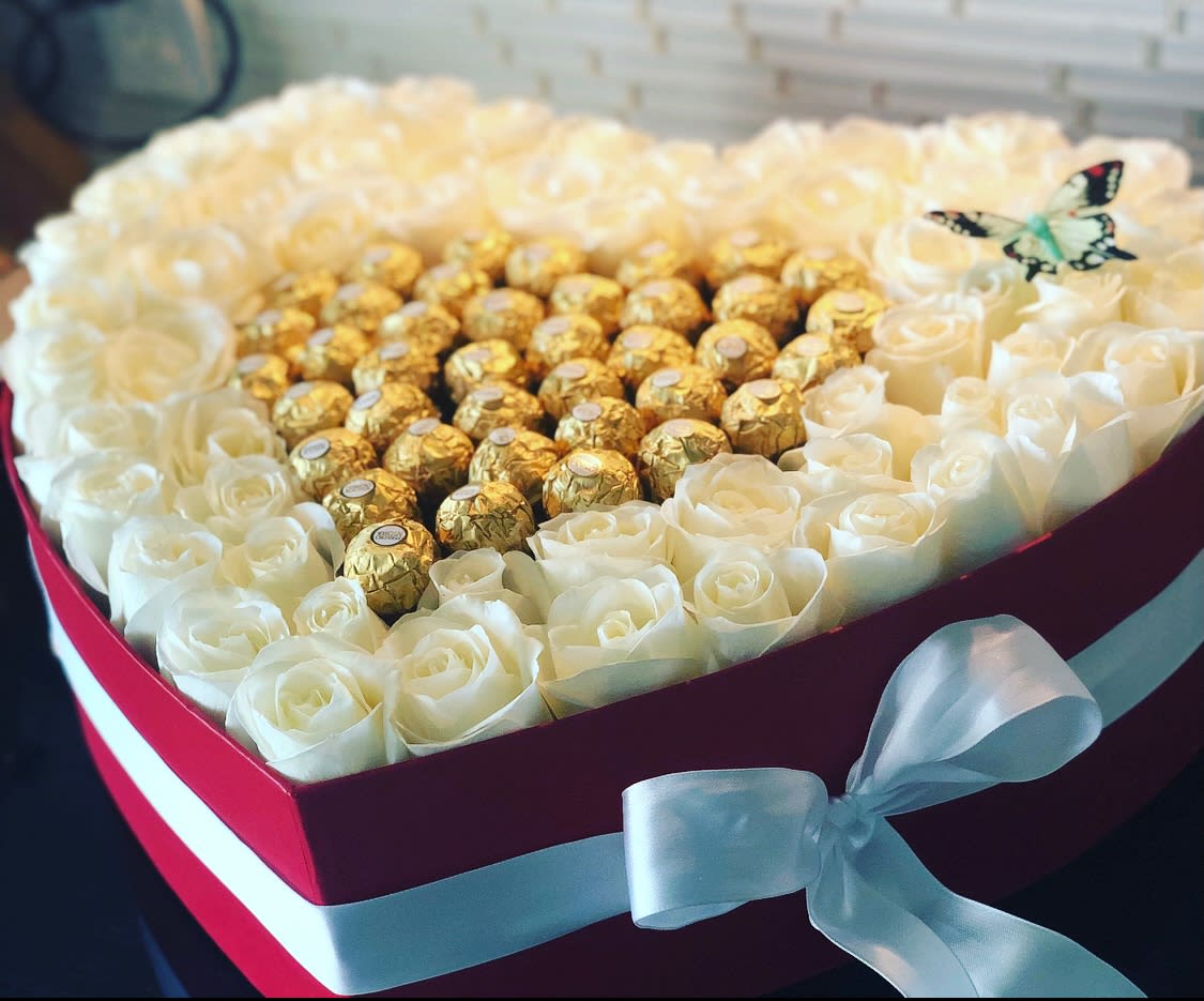 Heart-shaped box of white roses with gold-wrapped chocolates