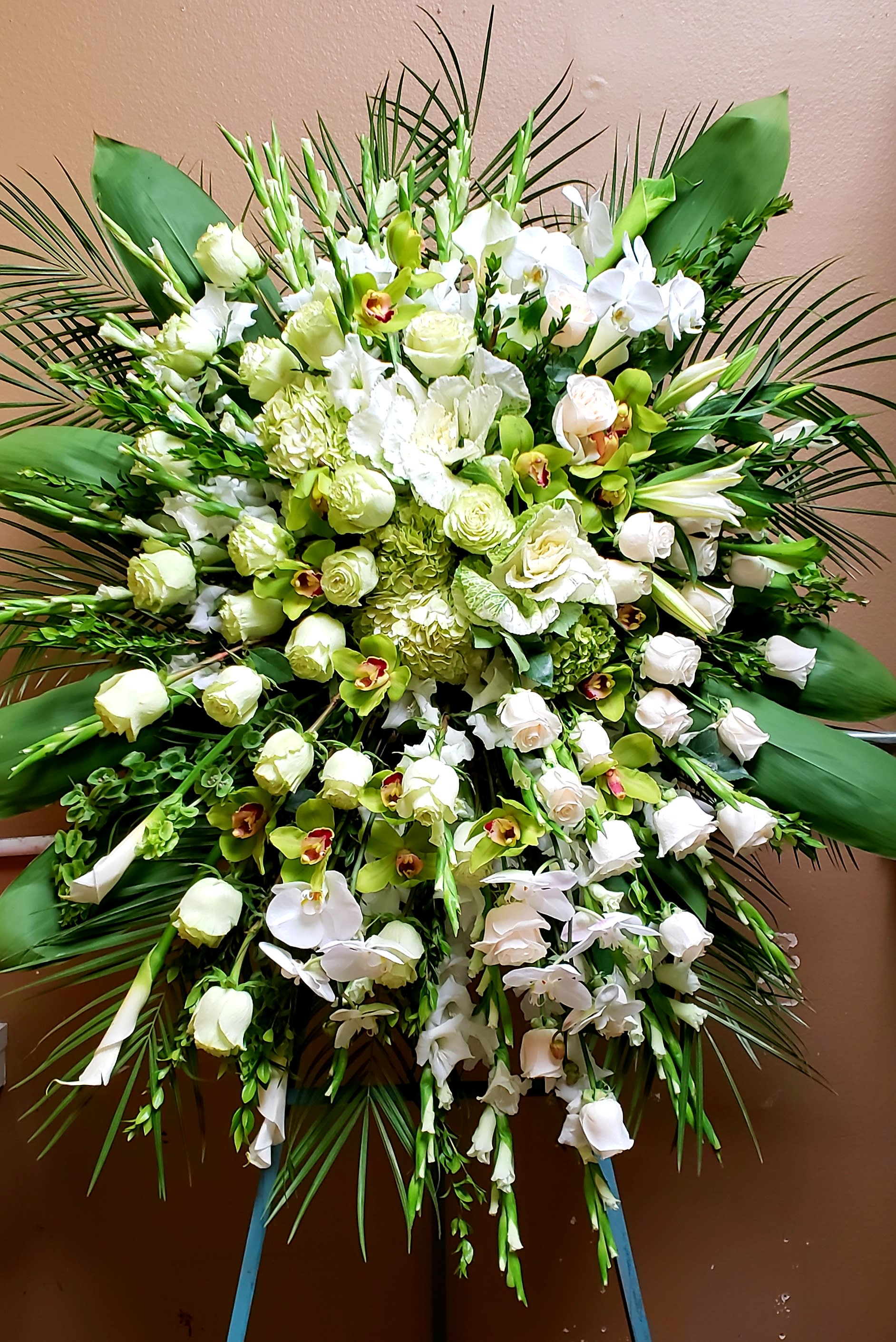 Large white and green floral standing spray with orchids and roses