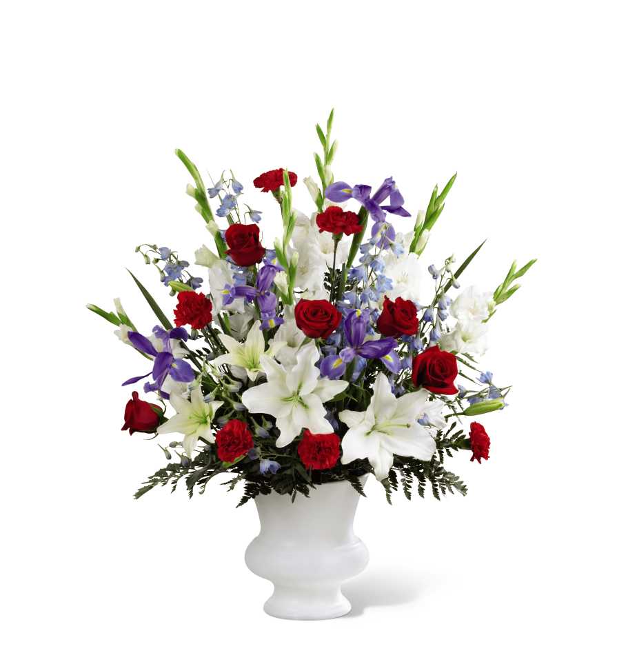 Red roses, white lilies, and purple flowers in a white vase