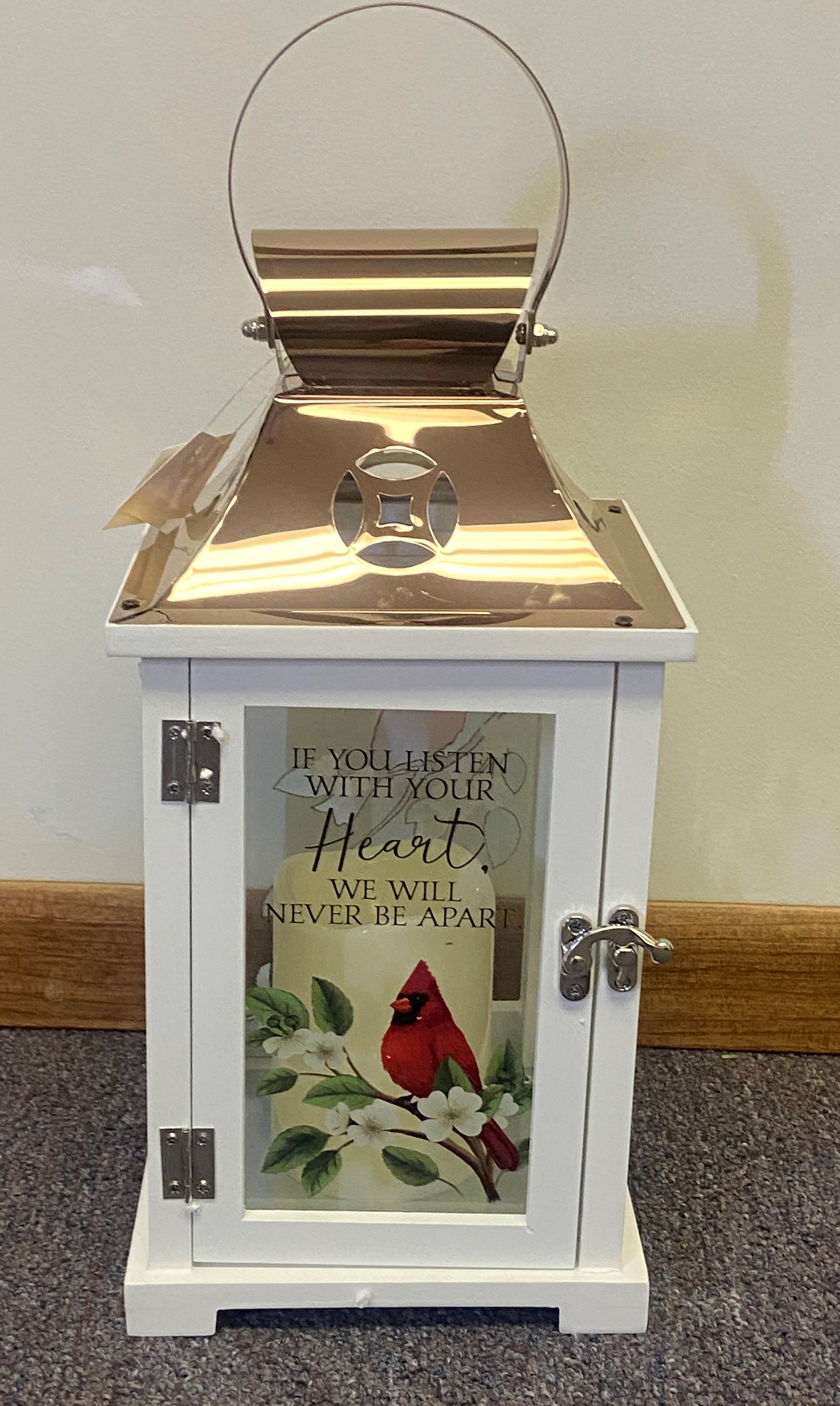 White lantern with a cardinal and floral print on the door