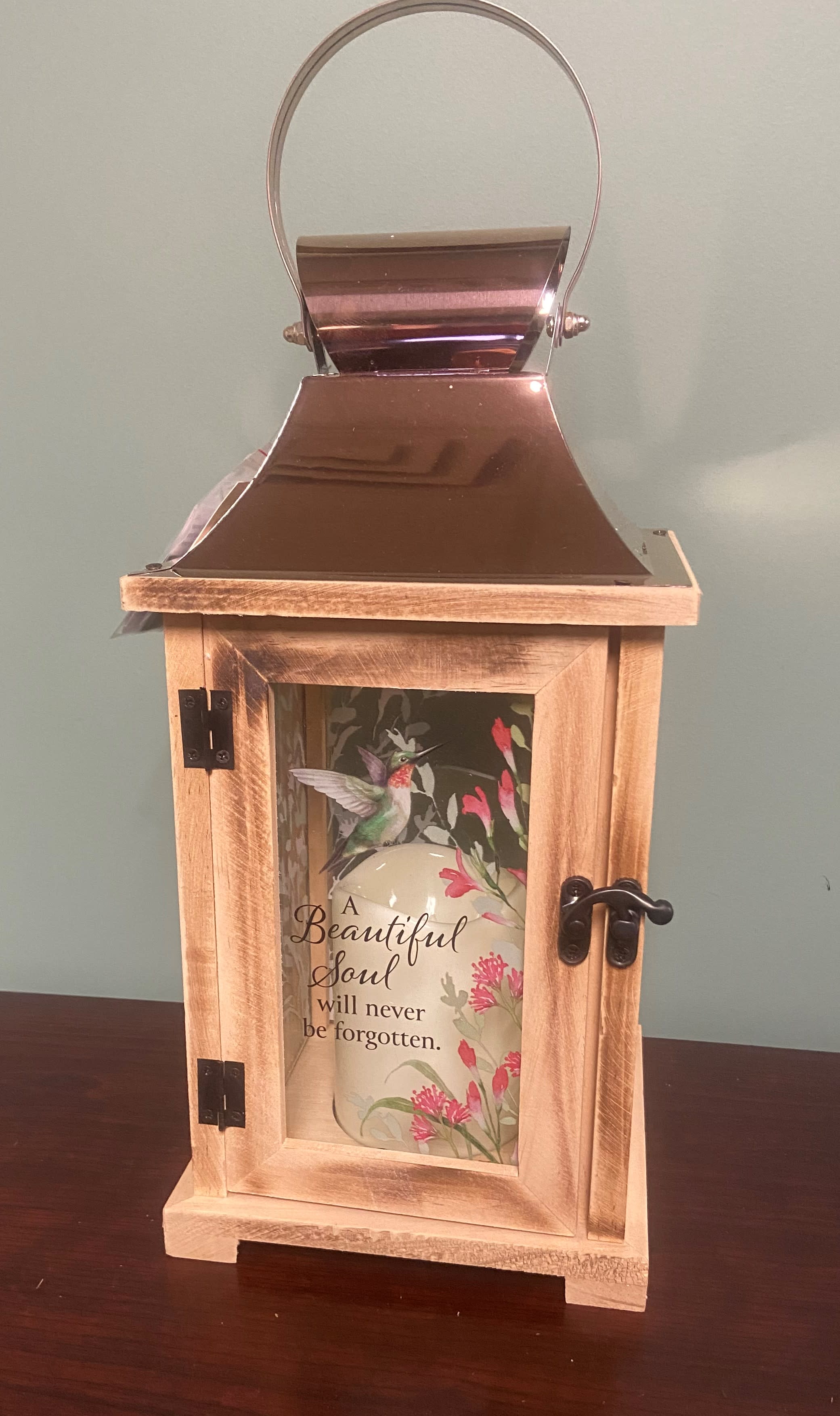Wooden memorial lantern with a hummingbird design and a candle inside
