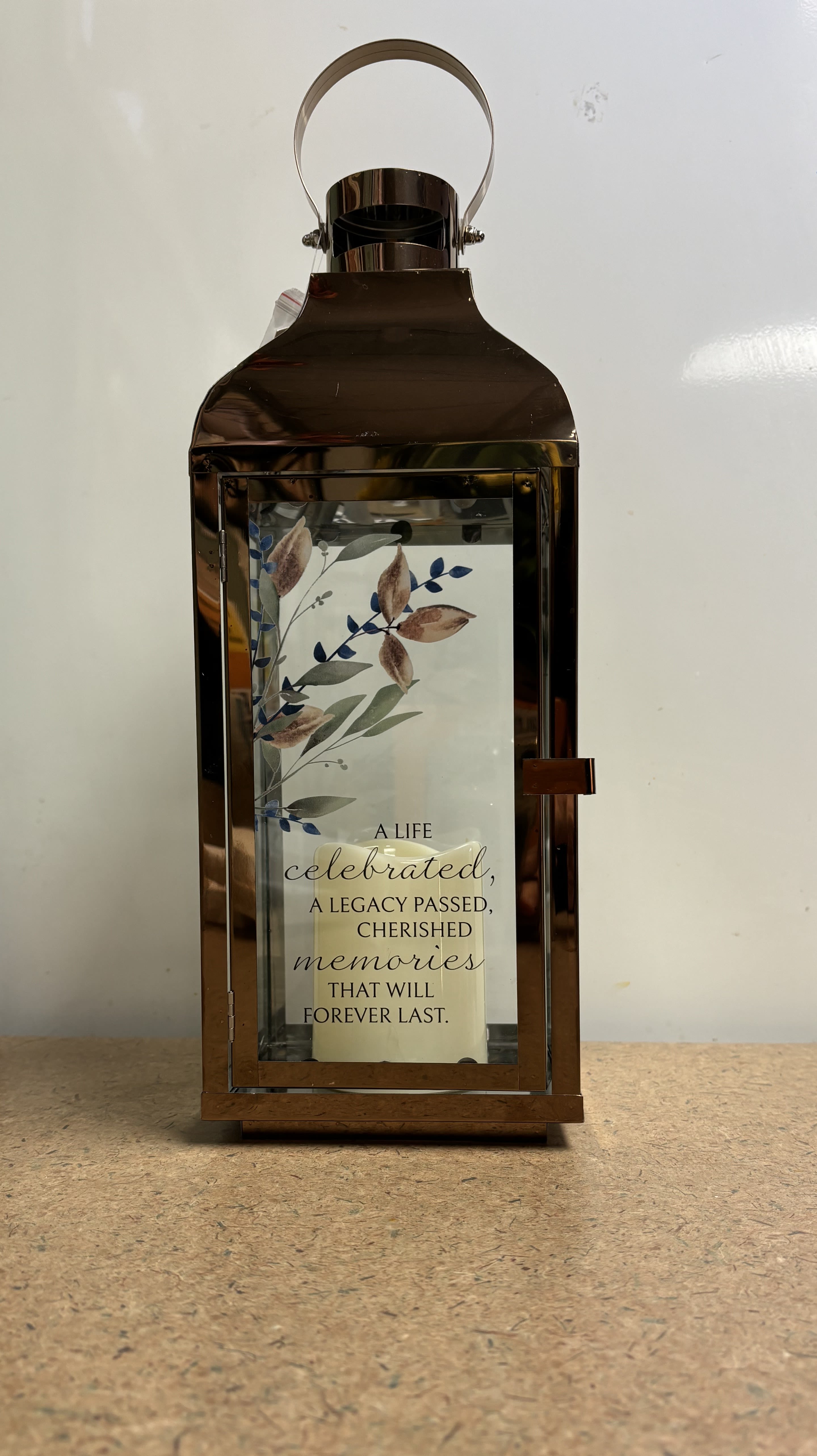 Bronze lantern with a memorial quote card inside