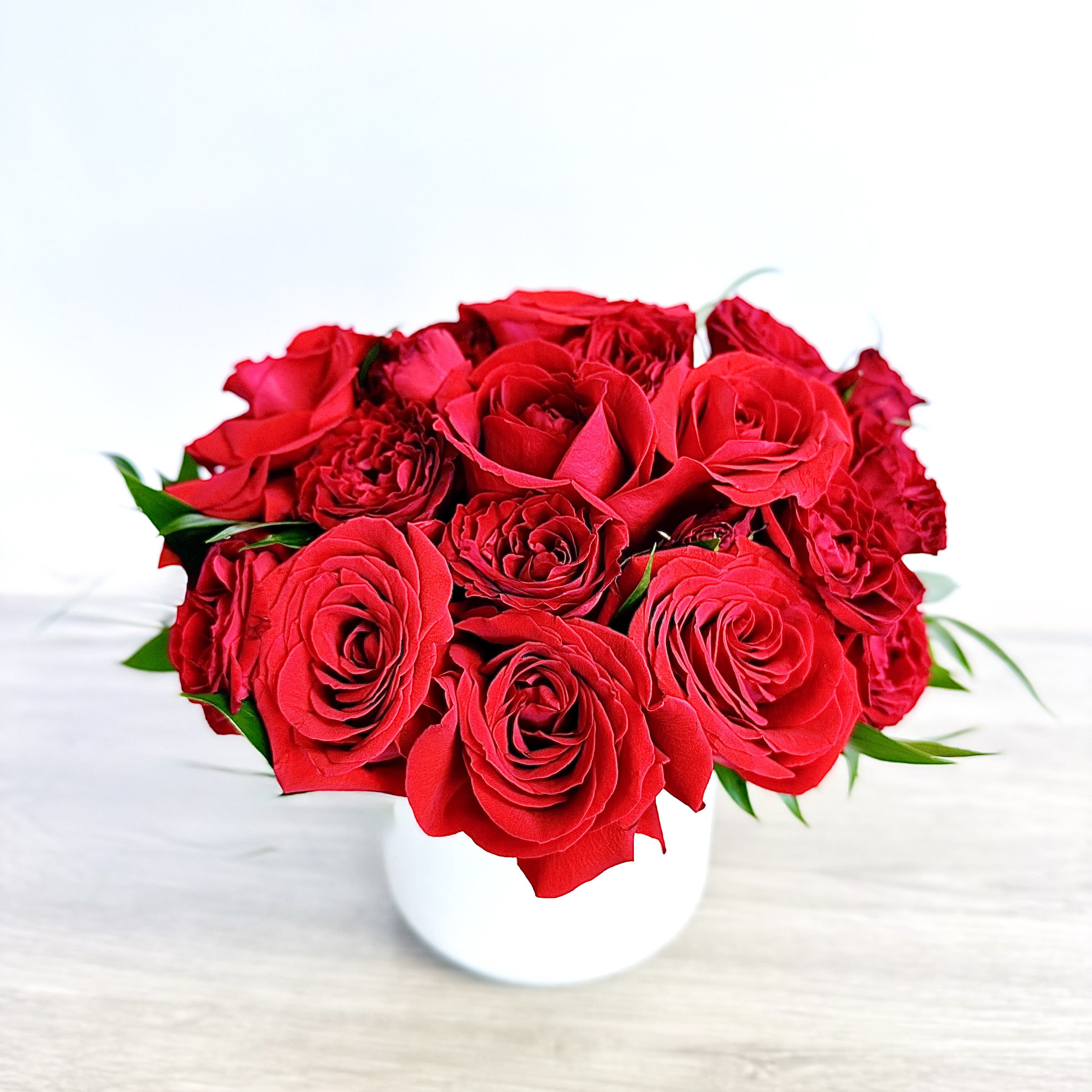 Red rose bouquet in a white vase