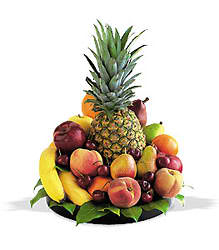 Tropical fruit arrangement with a pineapple, bananas, apples, and pears