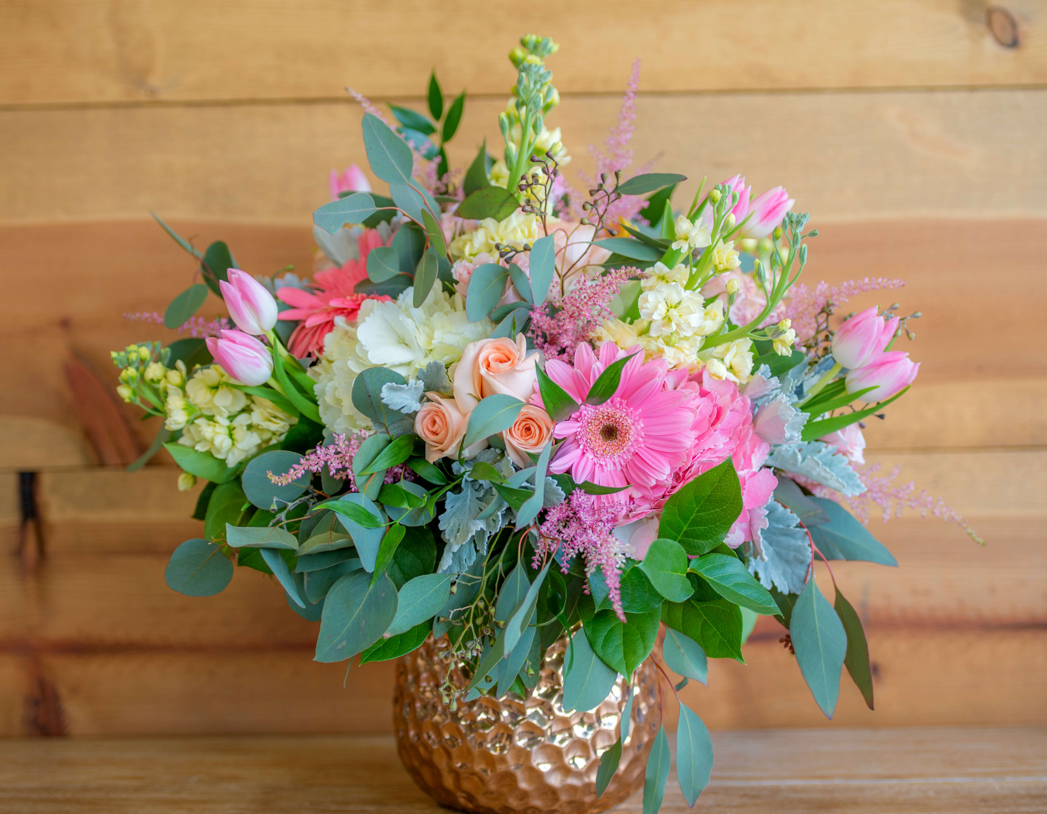 Pink and white mixed bouquet in a hammered gold vase