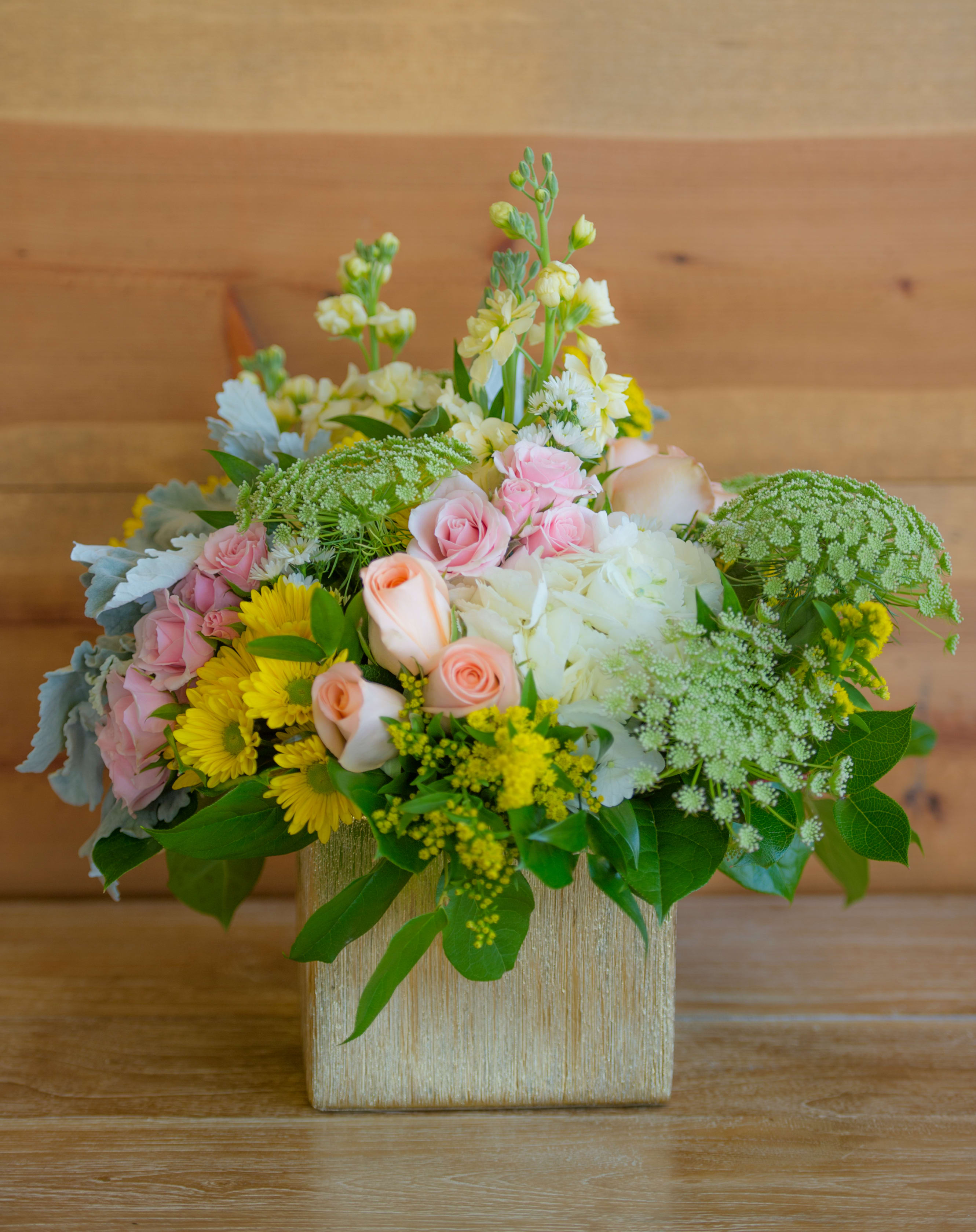 Mixed pastel bouquet in a square gold vase