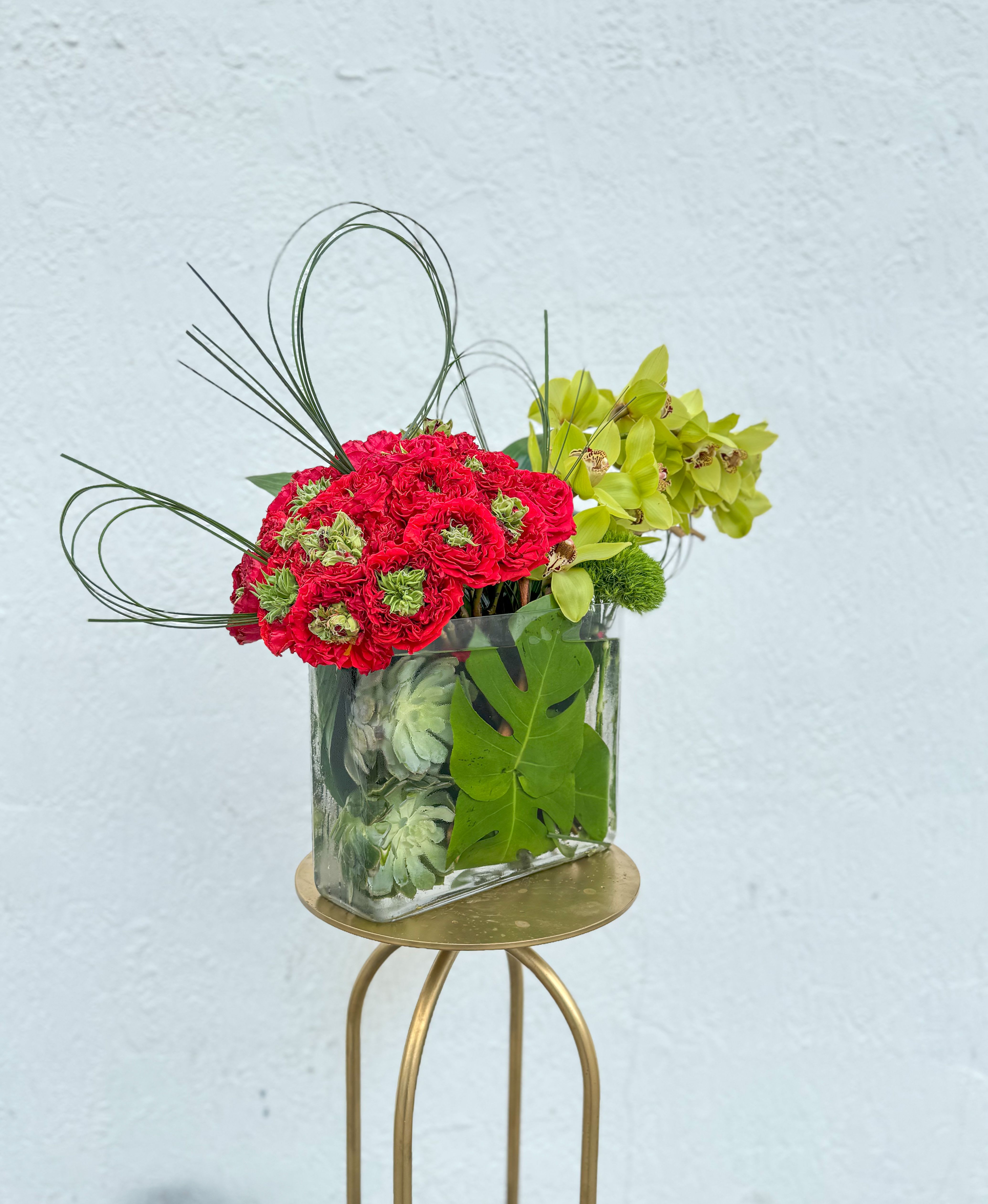 Rosalie - Bold, vibrant, and undeniably chic, Rosalie is the perfect blend of lush red blooms and fresh greenery, elegantly arranged in a modern glass vase.  These Monster Garden roses will be the talk of the office! 