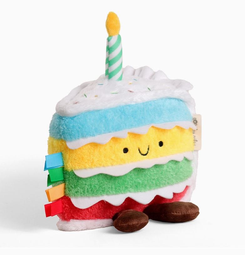 Plush slice of cake with a striped candle on top