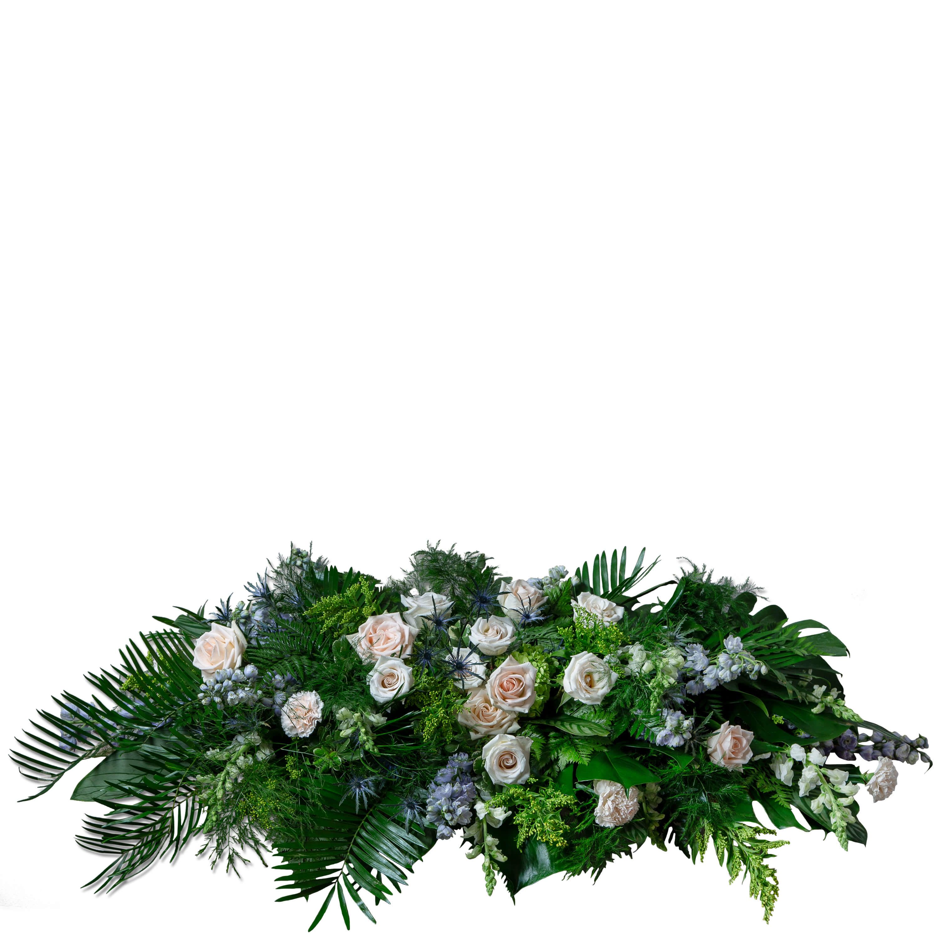 Heartfelt Remembrance Casket Spray  - This elegant casket spray providing a peaceful remembrance features premium blooms of snapdragons, delphinium, hydrangea, carnations, eryngium, roses and solidago in a soft spring color scheme of peaches, whites, lavender, blue and yellow.