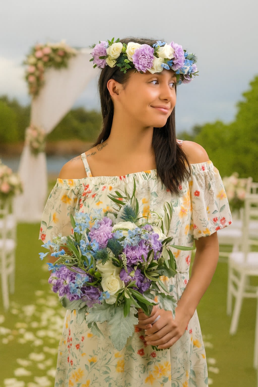 Woman holding a purple, blue, and white bouquet and wearing a matching floral crown outdoors