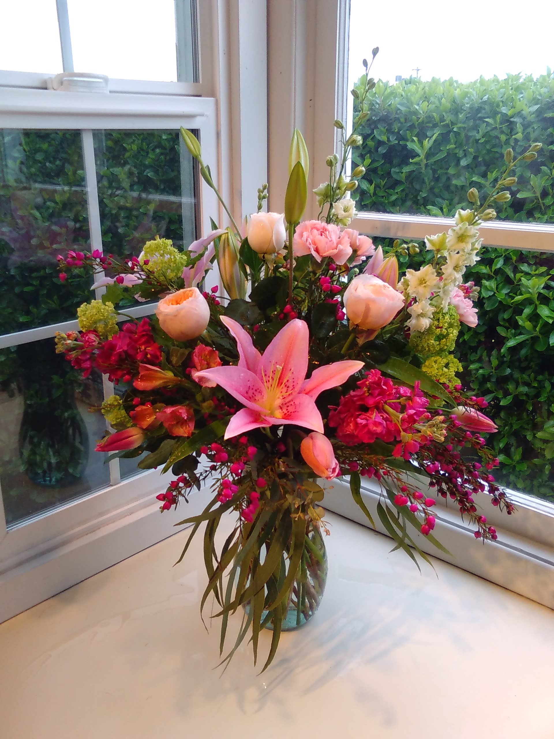 Pink lily and rose bouquet in a glass vase