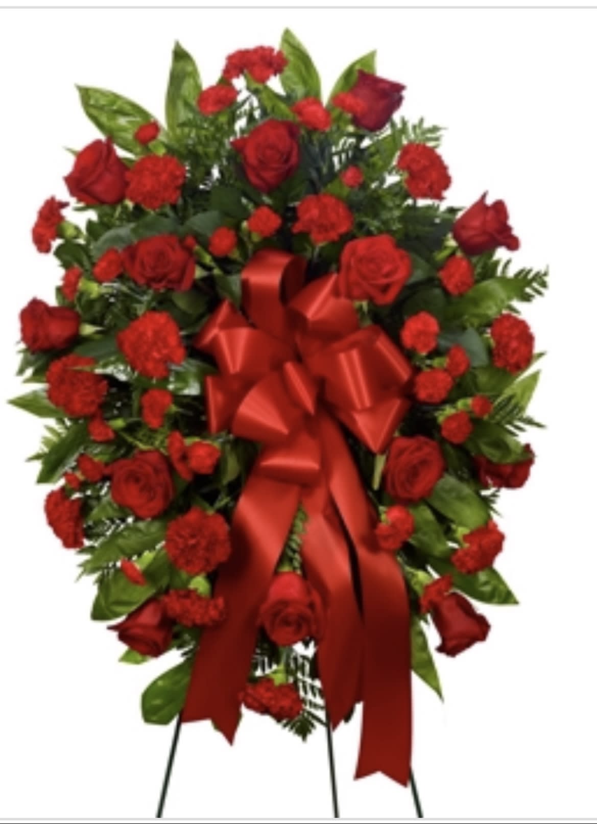 Red rose and carnation standing spray with a large red ribbon
