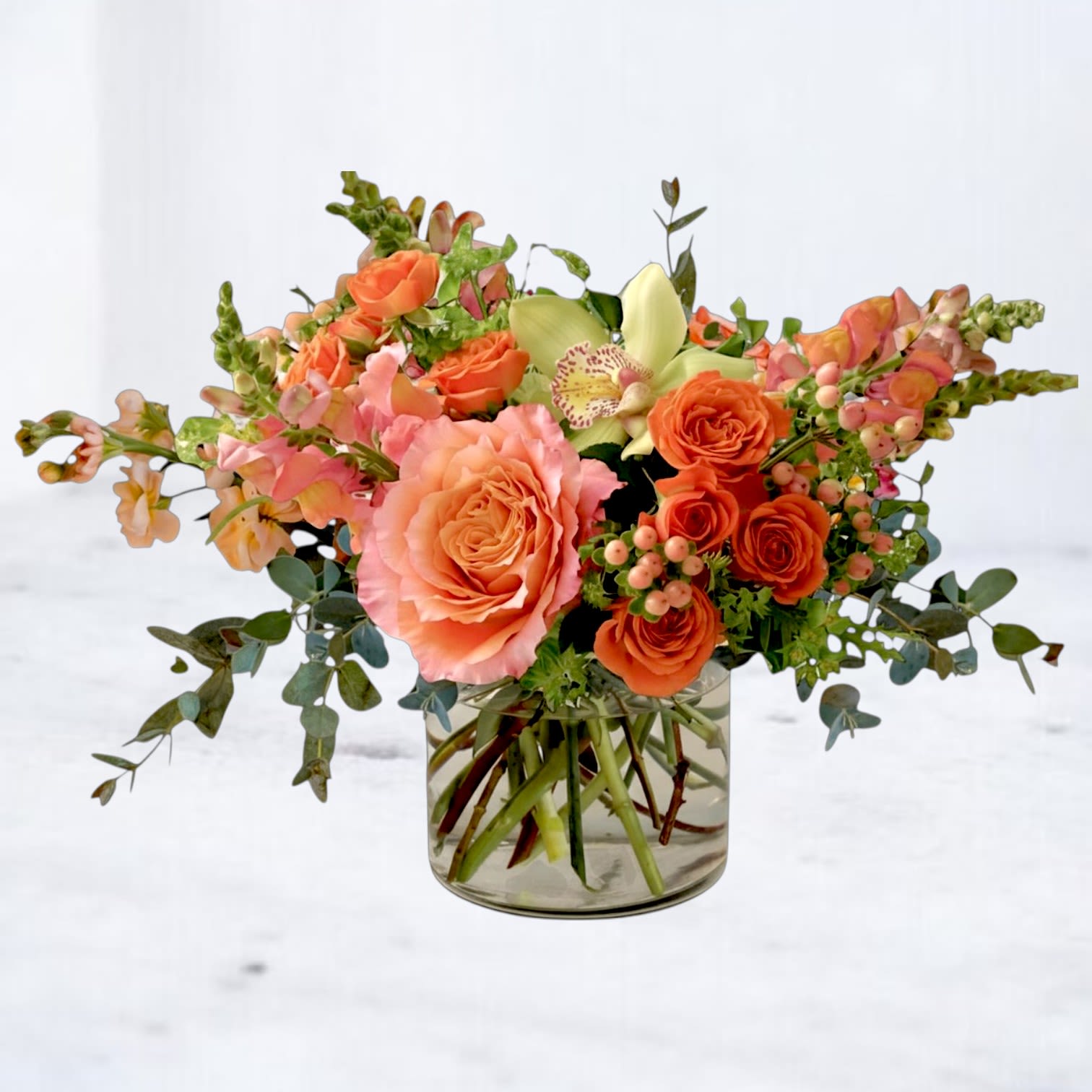Best Day - Best Day is a vibrant, garden-inspired floral arrangement designed to celebrate life’s happiest moments with warmth, color, and modern elegance. Featuring peach and coral roses, delicate orchids, soft pink blooms, and seasonal accent flowers, this arrangement is layered with fresh eucalyptus and greenery to create a naturally airy, textured composition. Designed in a clear glass vase, Best Day Bouquet blends soft sunset tones with fresh greens for a look that feels both uplifting and refined. The combination of premium blooms and organic movement gives this arrangement a polished, design-forward feel that stands out from traditional floral styles.  Perfect for birthdays, celebrations, congratulations, thank-you gifts, or just because, this peach and coral flower arrangement delivers a joyful, elevated design that instantly brightens any space.  Same-day flower delivery is available in Magnolia, TX, The Woodlands, Montgomery, Conroe, Spring, Tomball, and surrounding North Houston areas.  Due to seasonal availability, some blooms may be replaced with similar varieties of equal or greater value to maintain the design’s look and integrity. Your arrangement will always reflect the same color palette, style, and premium quality.