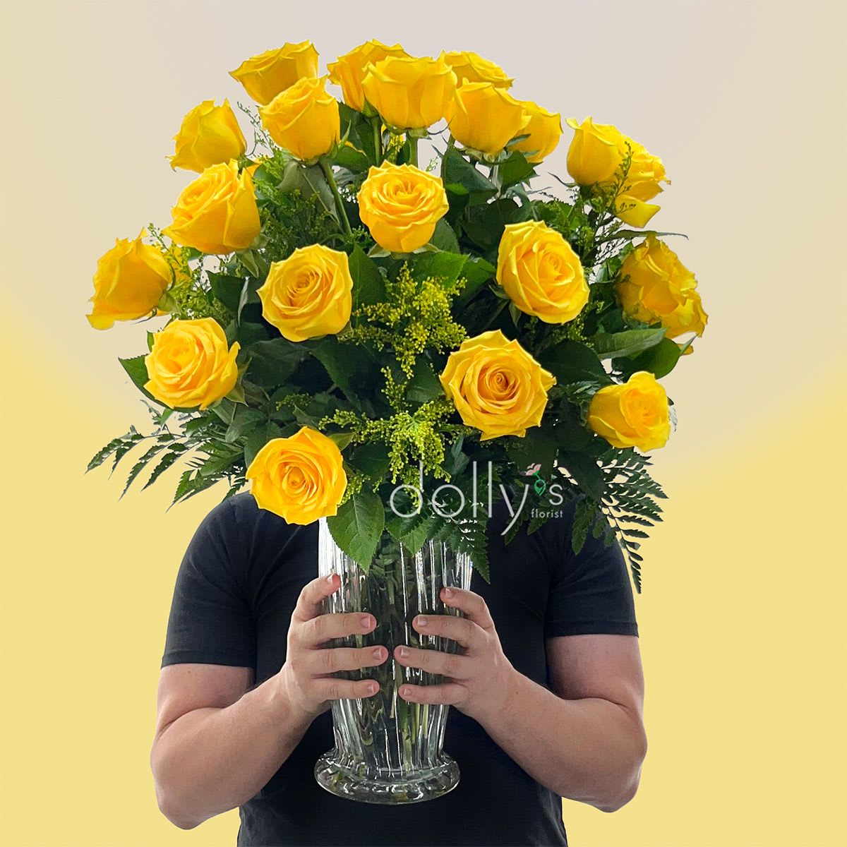Classic 2 Dozen Yellow Long-Stem Roses - A sunny cluster of long-stem yellow roses immediately brightens the room - the perfect birthday bouquet or "thinking of you" surprise that reads cheerful and sincere. This flower arrangement of 18 yellow roses is ideal for occasions from birthdays and graduations to get well wishes, apologies, or a simple "just because" that will make the person you're sending to feel truly seen. The warm yellow speaks to friendship, gratitude, and new beginnings, so it also fits perfectly for new baby celebrations, thank-you gifts, or a heartfelt token of love and romance.  The roses are gathered in a clear textured glass vase, arranged with dark green foliage that gives contrast and a fresh, abundant silhouette with blooms at slightly varied stages for natural movement and fullness. The overall palette of yellow, green, and touches of white creates a bright, uplifting display that sits nicely on a bedside table, desk, or dining table. Size and vase style make it easy to place; stems arrive ready to display - simply add water and enjoy.