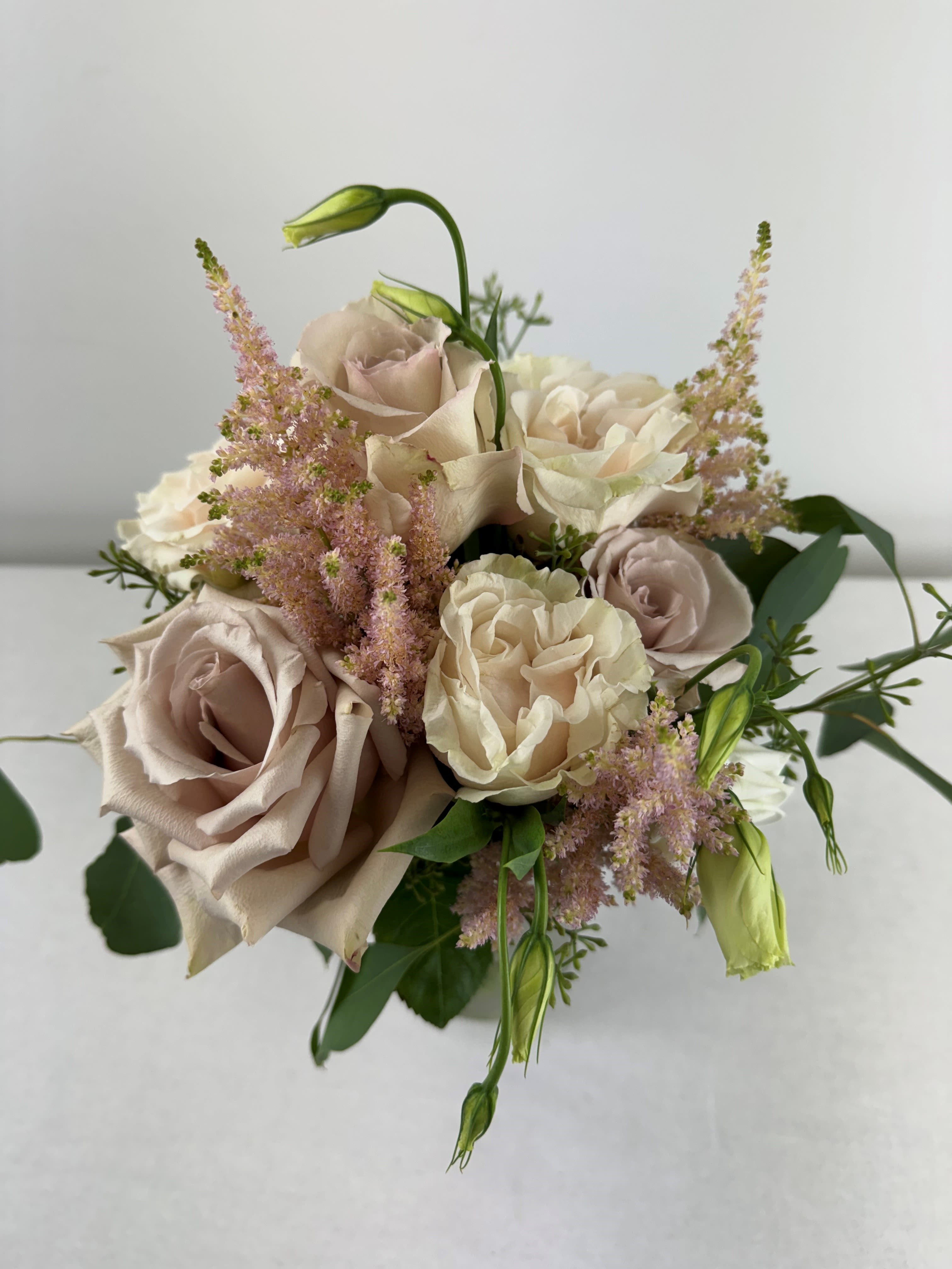 Bouquet of blush and cream roses with pink filler flowers