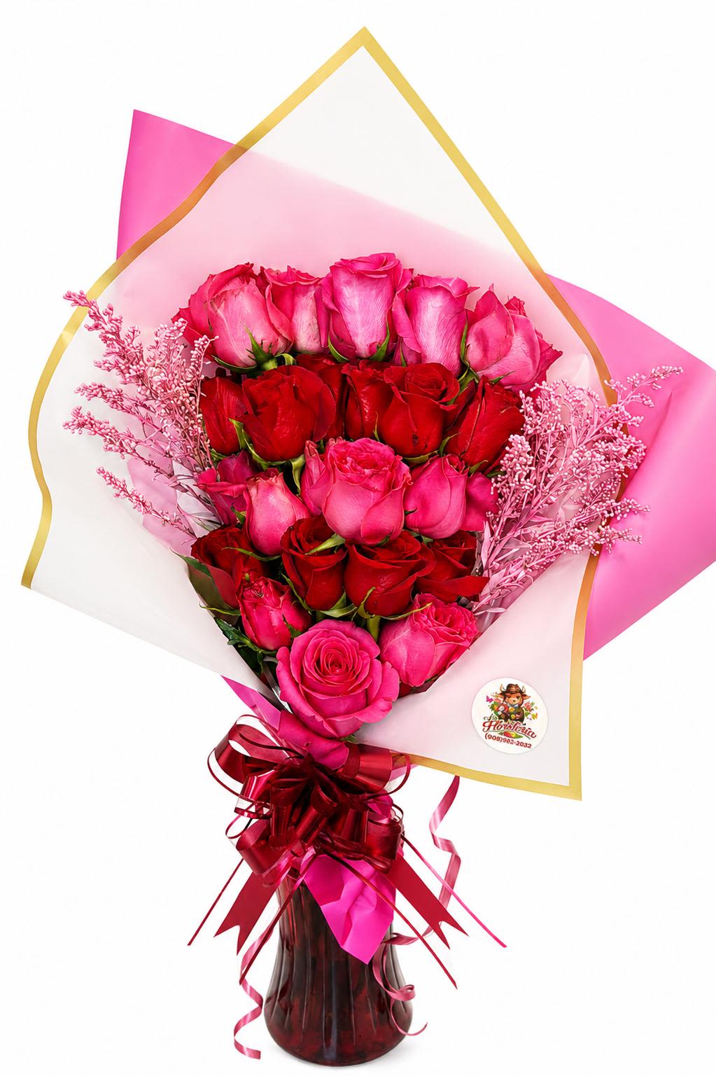 Ramo de Rosas Rojas y Fuscia - A lush cluster of red and fuchsia roses creates an immediate romantic statement-the kind of birthday, anniversary, or Valentine's Day bouquet that makes the person you're thinking of feel deeply cherished. This flower arrangement places tightly layered roses in a rounded, upright silhouette so the rich red and vibrant pink petals read like a single, sumptuous bloom from across the room, while pale pink filler branches soften the composition and add a tender, airy contrast.  Wrapped in translucent pink and white paper with subtle gold edging and finished with a glossy burgundy ribbon, the presentation is as gift-ready as the blossoms themselves. Choose to receive it in the included glass vase for a polished keepsake display; the arrangement's compact, rounded shape sits beautifully in standard table or bedside spaces. The blend of red, fuchsia, and soft accents makes this a heartfelt way to say "I love you," "feliz cumpleaños," or "congratulations"-a bouquet designed to make her feel truly seen and celebrated.