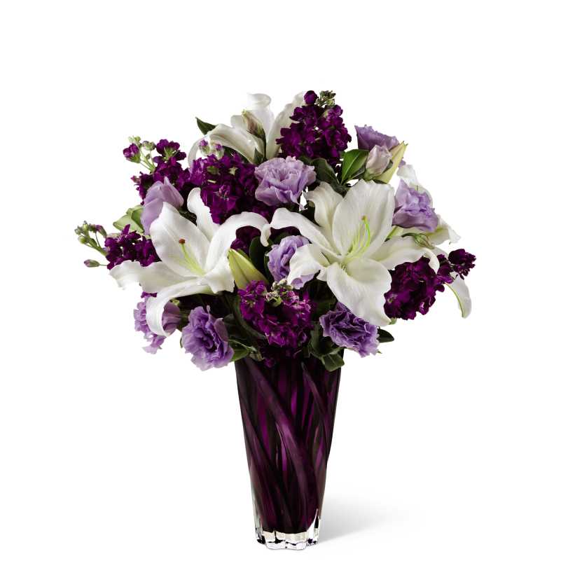 The FTD Loving Thoughts Bouquet - The FTD Loving Thoughts Bouquet is an exciting work of floral art in shades of white through deep purple and perfect for expressing your love on Mother's Day and any day. Fragrant white Oriental Lilies are surrounded by deep purple ruffled gilly flowers and stunning lavender double lisianthus. Presented in a deep purple glass vase, this mixed flower bouquet is a sweet and elegant way to celebrate any special occasion from Mother's Day to birthdays to anniversaries.