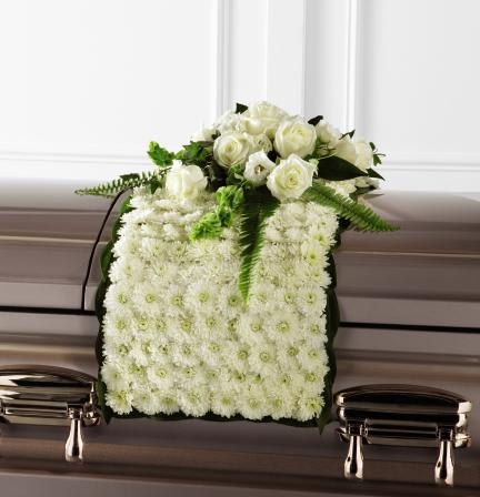 FTD Blanket of FLowers - "  The FTD Blanket of Flowers is a beautiful adornment for the top   of their casket at the final farewell service. White chrysanthemums form   a blanket of blooms that drape across the casket accented with an   arrangement of white roses, white double lisianthus, Bells of Ireland,   ivy, sword fern and a variety of lush greens to create an exquisite look   of sweet serenity to honor the life of the deceased.      0""h x 16""w  "