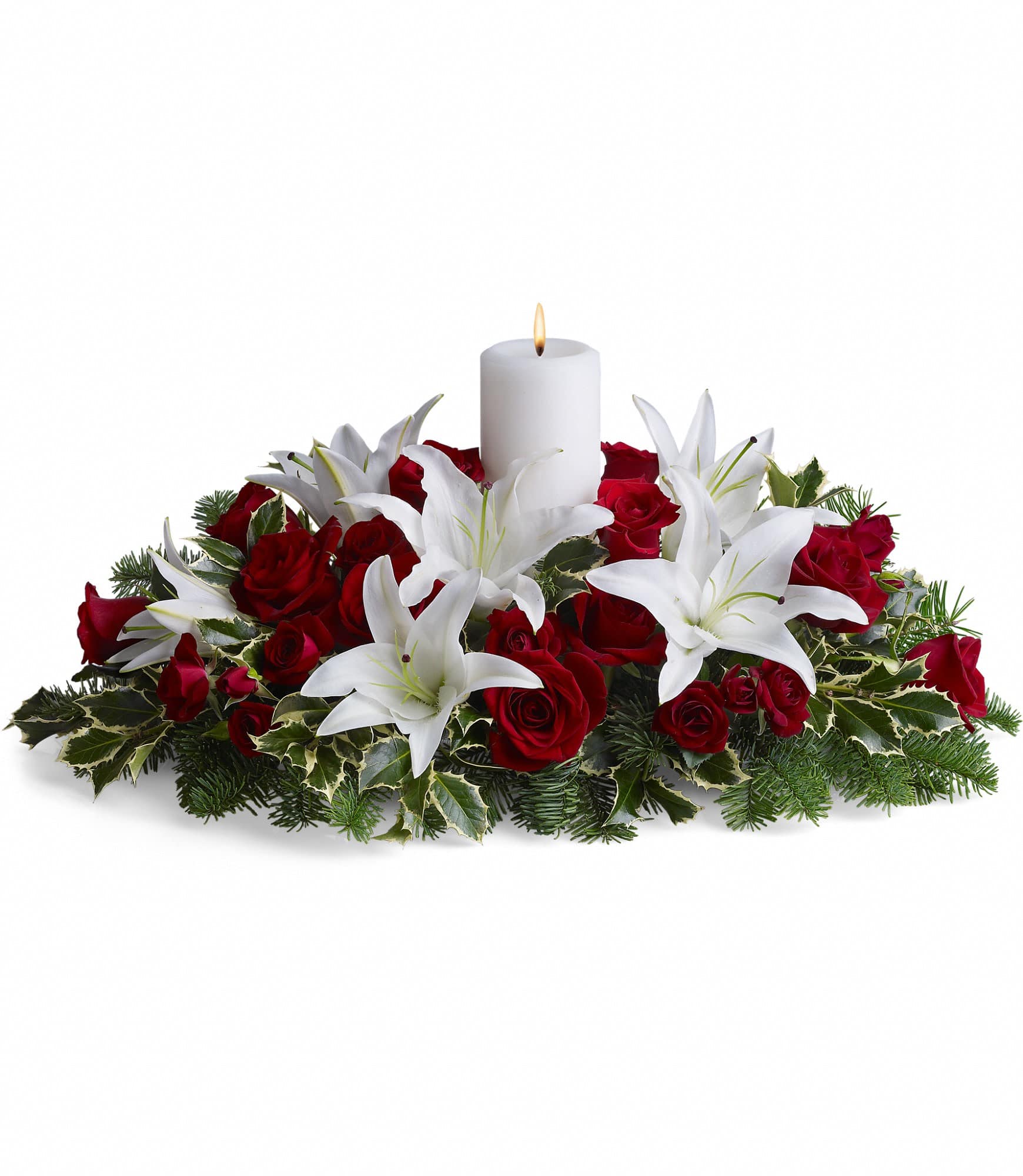 Luminous Lilies Centerpiece - This luminous centerpiece is a glowing way to spread the joy of the season. Whether displayed on the dining table or placed elsewhere, it will light up any room with holiday cheer.    Gorgeous pure white asiatic lilies, radiant red roses, spray roses and pretty winter greens are arranged around an elegant white pillar candle. It's regal and radiant.    Approximately 26" W x 14" H    Orientation: All-Around        As Shown : T128-3A      Deluxe : T128-3B      Premium : T128-3C    
