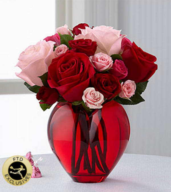 The FTD® My Heart to Yours™ Rose Bouquet - The FTD® My Heart to Yours™ Rose Bouquet is a stunning way to get your sweetheart in the mood for love this coming Valentine's Day! Simply gorgeous roses in the shades of pink and red are offset by spray roses in red, hot pink, and pale pink hues to create an exceptional fresh flower arrangement. Presented in a red heart-shaped glass vase, this beautiful rose bouquet will convey your heart's deepest emotions in celebration of this most romantic day. Your purchase includes a complimentary personalized gift message.