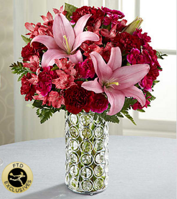 The FTD® Perfect Impressions™ Bouquet - When the bouquet just has to "dazzle," this wonderful mixed flower arrangement makes a perfect and exciting choice. This gorgeous composition of carnations, lilies and roses (in Deluxe, Premium and Exquisite) in blushing shades that range from pale pink to burgundy to plum, is beautifully hand-arranged in a chic and sparkling vase of faceted "gems" set into a silvery metal-framework holding a clear glass insert. Your purchase includes a complimentary personalized gift message.