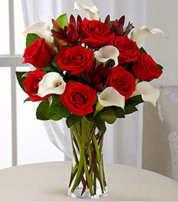 Memorable Moments Bouquet - VASE INCLUDED - Picked fresh from the farm to bring modern elegance into their everyday, our Memorable Moments Rose &amp; Mini Calla Lily Bouquet is blooming with gorgeous grace to celebrate love and life with each treasured bloom. Hand gathered in select floral farms and showcasing the winning color combination of red and white, this stunning flower arrangement has been picked fresh for you to help you celebrate Christmas, a birthday, anniversary, or convey your message of heartfelt love and affection. This bouquet includes the following: red roses, white mini calla lilies, and an assortment of lush greens. Available with a selection of vases to fit your gifting needs. GOOD bouquet includes 15 stems with clear glass vase. Approximately 16"H x 15"W. BETTER bouquet includes 19 stems with clear vase. Approximately 17"H x 15"W. BEST bouquet includes 23 stems with clear glass vase. Approximately 18"H x 16"W. Your purchase includes a complimentary personalized gift message.
