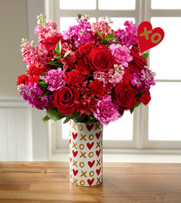 Heart of Hearts Valentine's Day Bouquet - Heart Pick &amp; VASE INCLUDED - Picked fresh from the farm to bring bright beauty and a sweet surprise to their day, our Heart of Hearts Valentine's Day Bouquet sends your hugs and kisses across the miles in honor of this most romantic holiday. Hand gathered at select floral farms and bringing together a collection of fragrant brilliantly blushing blooms, this gorgeous mixed flower bouquet has been picked fresh for you to help you sweep your special someone off their feet this coming February 14th. Bouquet includes: fuchsia carnations, red roses, pink gilly flower, hot pink gilly flower, red Peruvian Lilies, red mini carnations and lush greens. Available with or without a ceramic white vase with gold X's &amp; O's and pink heart design.  GOOD bouquet is approx. 15"H x 11"W. BETTER bouquet is approx. 16"H x 12"W. BEST bouquet is approx. 17"H x 13"W. Your purchase includes a complimentary personalized gift message.