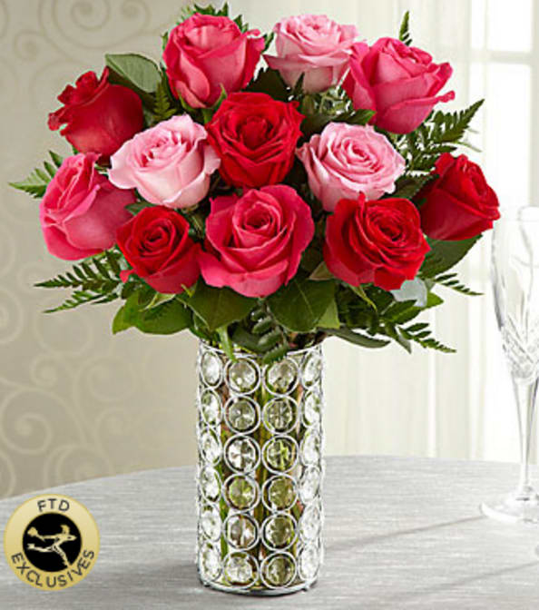 The FTD® Art of Love™ Rose Bouquet - Mastering the art of love can be much easier than you think, especially when the expression of your feelings bloom with this lush and luscious rose bouquet. The simply spectacular gathering of roses in sweet pink and passionate red are hand-arranged by at FTD artisan florist in a chic and sparkling vase of faceted "gems" set into a silvery metal-framework holding a clear glass insert. Your purchase includes a complimentary personalized gift message.