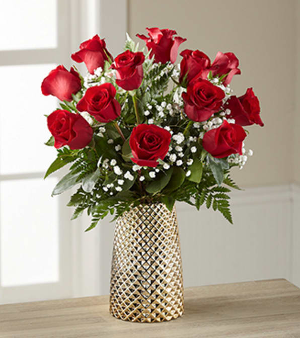 Heart of Gold Rose Bouquet -12 Stems - VASE INCLUDED - Picked fresh from the farm to bring a classic elegance to your special recipient's everyday, our Heart of Gold Rose Bouquet is both beautiful and truly romantic to help you convey your heart's every emotion. Hand gathered at select floral farms and flaunting a rich red hue, this gorgeous rose bouquet has been picked fresh for you to help you celebrate a birthday, anniversary, Valentine's Day, or to simply let them know they are always on your mind. Bouquet includes: a dozen red roses, baby's breath, and lush greens. Presented with a modern shining gold metallic vase. Bouquet is approximately 19" H X 16"W Your purchase includes a complimentary personalized gift message.