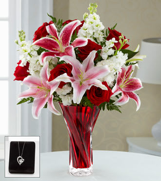The FTD® Anniversary Rose Bouquet with Pendant - A1JD  The FTD® Anniversary Bouquet blossoms with roses and lilies to display your love and affection in classic grandeur. Rich red roses, eye-catching Stargazer lilies, and pink Oriental lilies are accented with fragrant white stock and lush greens to form an impressive flower arrangement. Presented in a designer red glass vase, this mixed flower bouquet is set to express your heart's every emotion with its endless beauty and elegance. Pendant measures 5/8" including bale. 18-inch sterling silver box chain with spring ring closure. Includes a single 1-1/2-ct round cut genuine white topaz. Imported