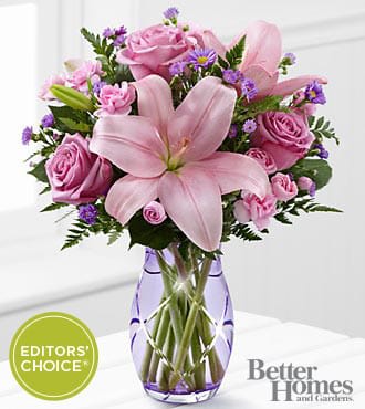 The FTD® Graceful Wonder™ Bouquet by Better Homes and Gardens® - GWBS  The FTD® Graceful Wonder Bouquet by Better Homes and Gardens® blushes with floral beauty to send your special recipient your most heartfelt sentiments. Lavender roses and pink Asiatic Lilies are surrounded by pink mini carnations and purple Monte Casino asters to create an incredible flower arrangement. Presented in a designer lavender cut glass vase, this mixed flower bouquet will make the perfect impression on their birthday, anniversary, in celebration of the birth of a new baby girl, or as a way to express your thanks and gratitude.