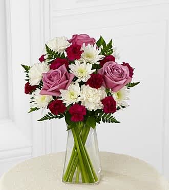The FTD® My Sweet Love™ Bouquet - B18B-4947  The FTD® My Sweet Love™ Bouquet sends fresh color and light to their door. Stunning lavender roses and purple mini carnations make the ultimate statement surrounded by white carnations and chrysanthemums all beautifully accented with lush greens to create an exquisite flower arrangement. Presented in a modern clear glass vase, this flower bouquet blooms with your most heartfelt wishes.