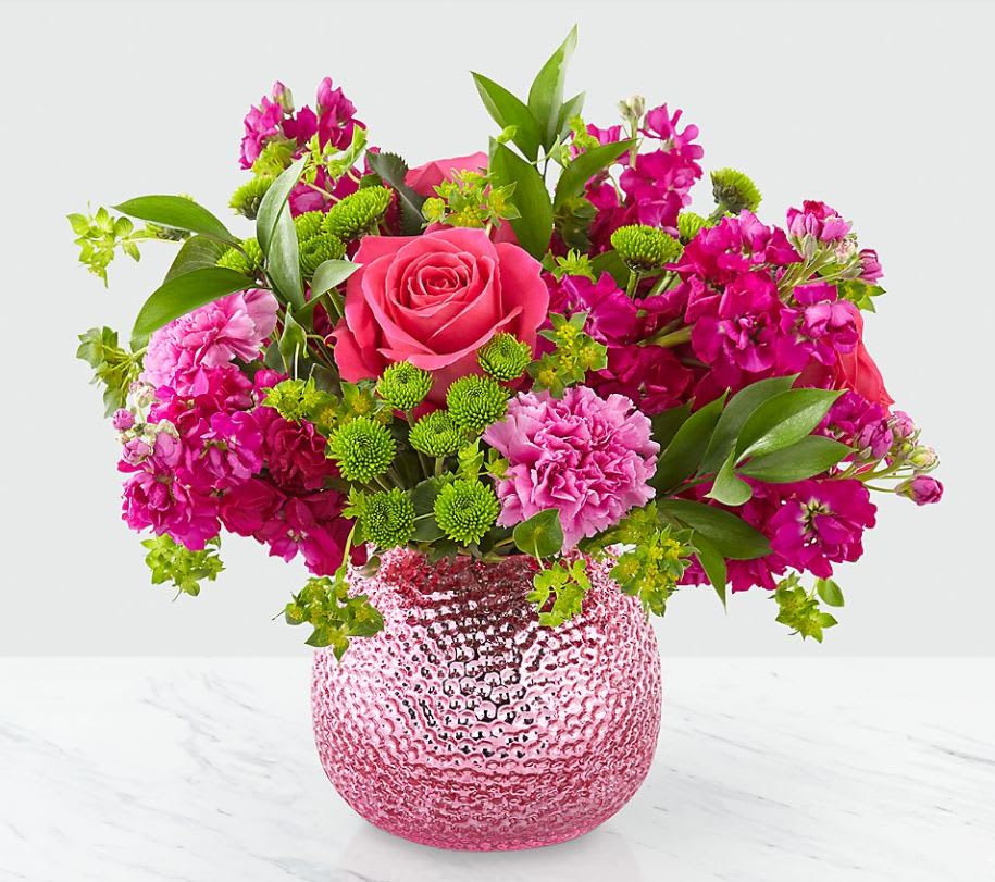 Cherry Blossom - Much like the beauty from the change of season, our Cherry Blossom™ Bouquet is bursting with color. Sweet hot pink roses, stock and carnations are complemented by green button pompons to make their day so much brighter!