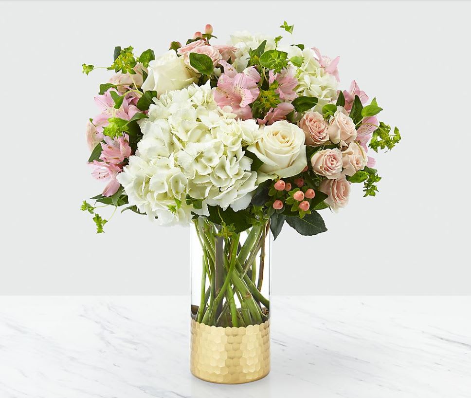 Simply Gorgeou Bouquet - Our Simply Gorgeous™ Bouquet is a gift they will simply never forget. This fresh bouquet is filled with blushing, beautiful texture and soft pastel hues to complement any message of love. It's handcrafted with spray roses, roses and hydrangea in a shining metallic gold vase for your special people.