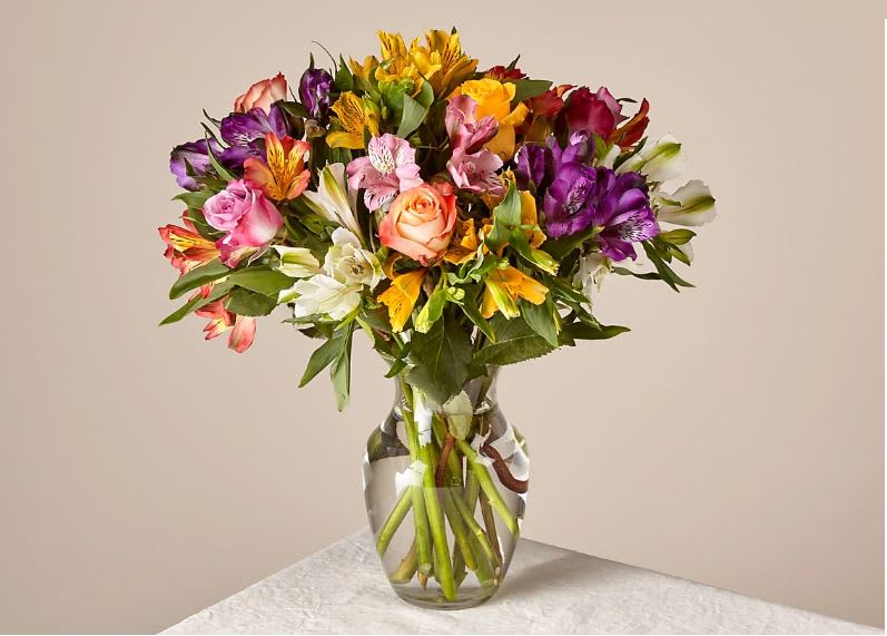 Smiles &amp; Sunshine - Bring a rainbow of color to any home with this bouquet. Blooming with an assortment of alstroemeria and roses, this vibrant beauty makes the perfect expression for all your special occasions this season.  The Original Bouquet is approximately 17"H by 15"W.