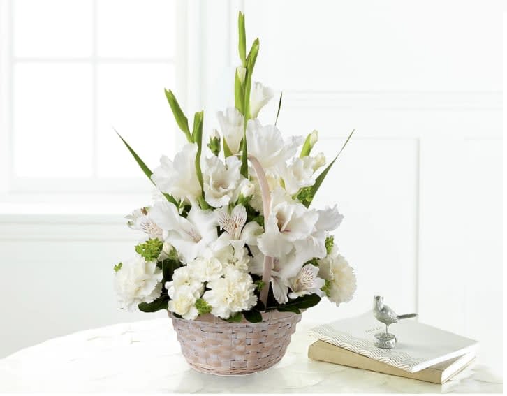 Eternal Affection Arrangement - Our Eternal Affection Arrangement is a simple yet elegant offering of your sympathy. A mix of fresh, white florals are beautifully arranged in a round handled basket to create a display of soft serenity. While it's perfectly sweet in size, this pick is best suited to be placed on a table or within a home.