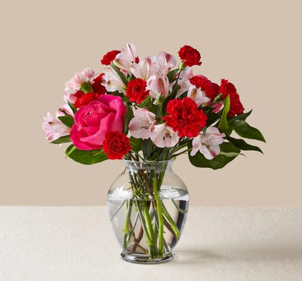 You're Precious Bouquet - Blushing shades of pink blooms are nestled in lush greens to charm anyone's day. This bouquet is abundant with a classic assortment of pretty florals – roses, alstroemeria and carnations to name a few.  The Original Bouquet is approximately 12"H x 13"W.