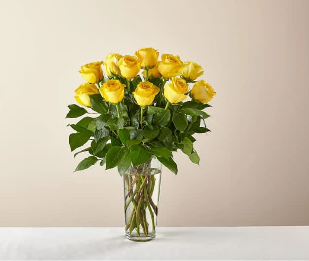 Long Stem Yellow Rose Bouquet - Nothing brightens someone's day quite like the sunny shade of yellow. While vibrant yellow roses are a symbol of friendship, this bouquet makes a welcomed gift for any loved one.  The Original Bouquet is approximately 21"H x 16"W.