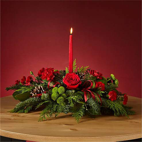  By the Candlelight Centerpiece - Let time fly By the Candlelight centerpiece as new holiday memories are made. What better way to commemorate the joyful homecoming than with classic red roses and lush evergreen accents?