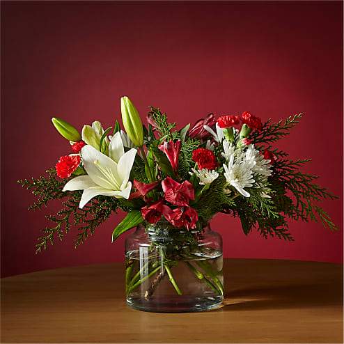 Holiday Vacation Bouquet - Pack your bags for a relaxing escape with this Holiday Vacation Bouquet. Experience a floral getaway full of ivory lilies and red carnations and feel refreshed to ring in the New Year.