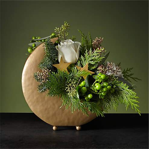 Stardust Bouquet - Drift off to visions of sugar plums under the Stardust Bouquet. This dreamy piece is arranged in a metal moon vase with stars nestled around the petals. Its white roses and delicate Christmas greenery will calm your space for a peaceful night.
