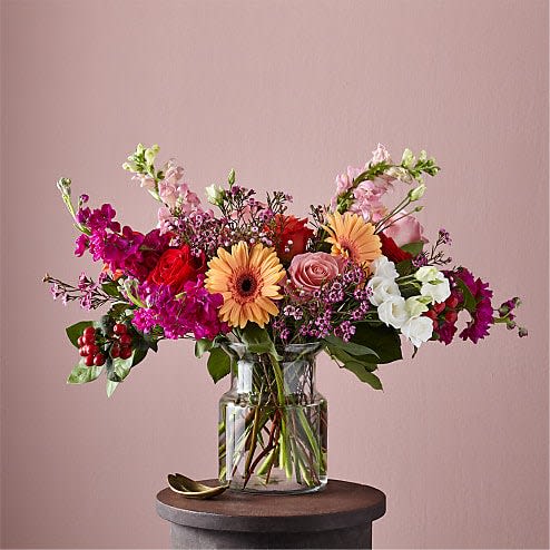 Grand Gesture Bouquet - Show them how you really feel with our Grand Gesture Bouquet. The peach gerbera daisies and pink roses anchor the arrangement, letting the hot pink waxflower, white lisianthus and pink snapdragons extend outward. This stunning bouquet will have your inner hopeless romantic ready for that storybook ending.